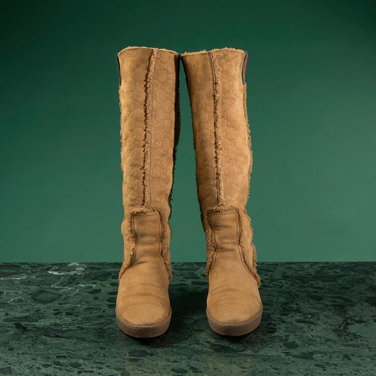 A pair of boots by GUCCI in size 39.