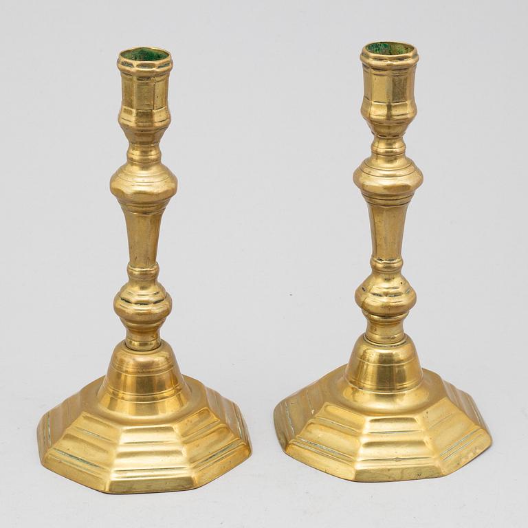 A pair of 18th century bronze candlesticks.