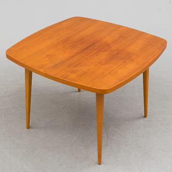 A 1950s teak and teak veneer table.