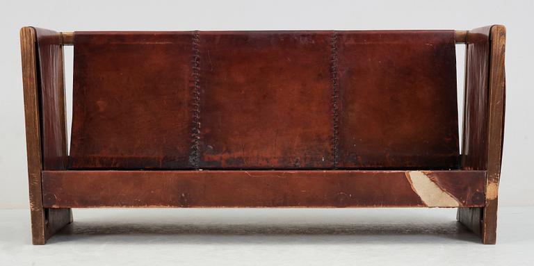 An Axel Einar Hjorth 'Funkis' brown leather and stained wood sofa, Nordiska Kompaniet, Sweden 1930's.