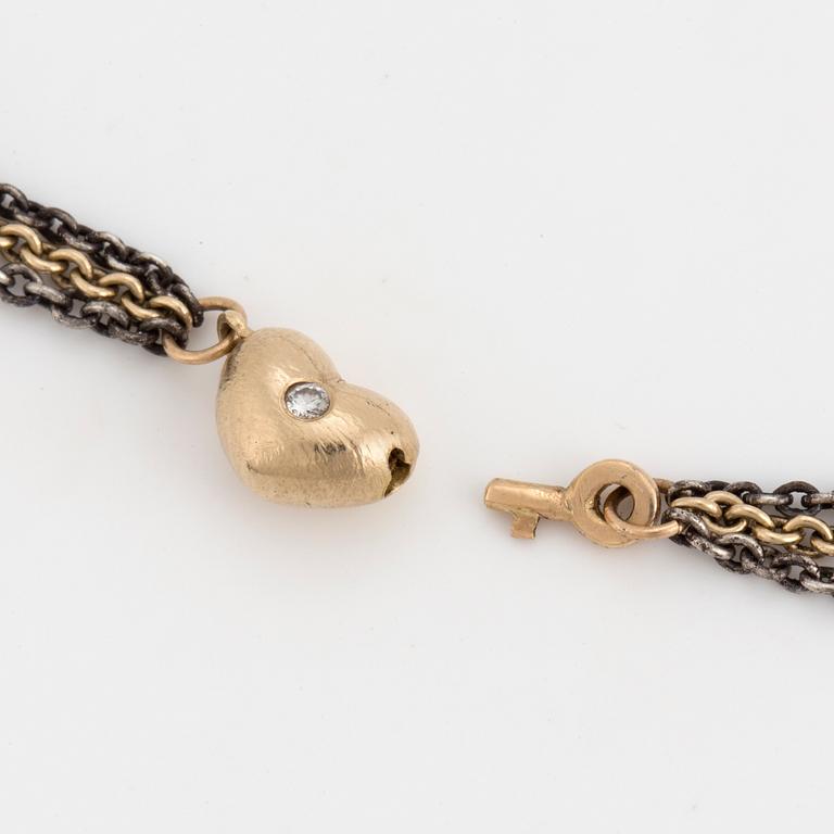 A necklace by Ole Lynggaard, the clasp decorated with a diamond.