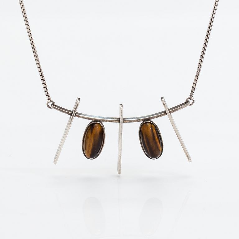 Kaulakoru, hopeaa ja tiikerinsilmää. Eero Eskelinen, Helsinki 1959.