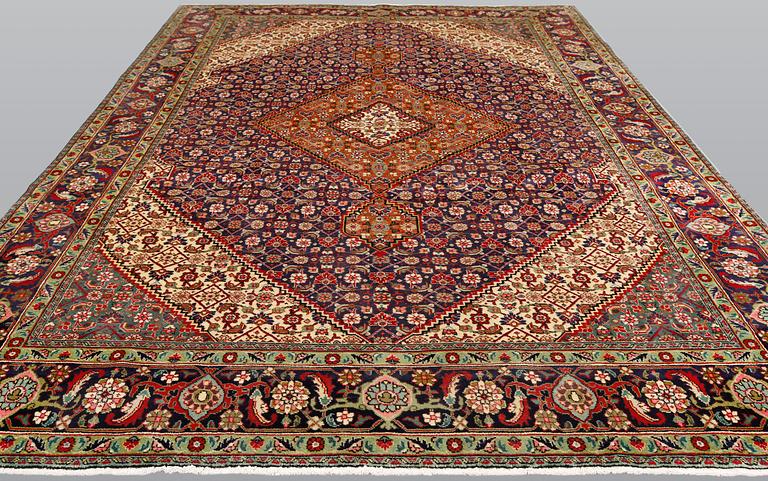 A Tabriz carpet, approximately 360 x 255 cm.