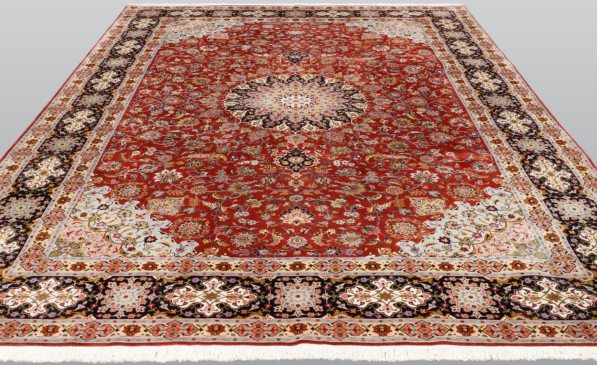 A Tabriz carpet, part silk, so-called 50 Raj, approx. 352 x 250 cm.