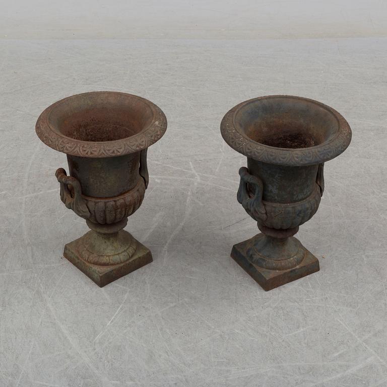 A pair of 20th century iron garden urns.