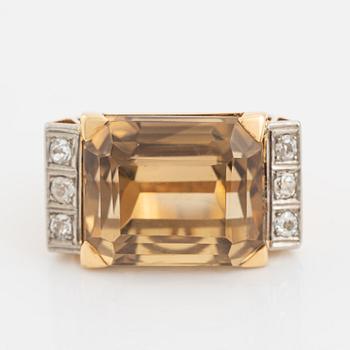 An 18K gold ring set with faceted quartz and old-cut diamons.