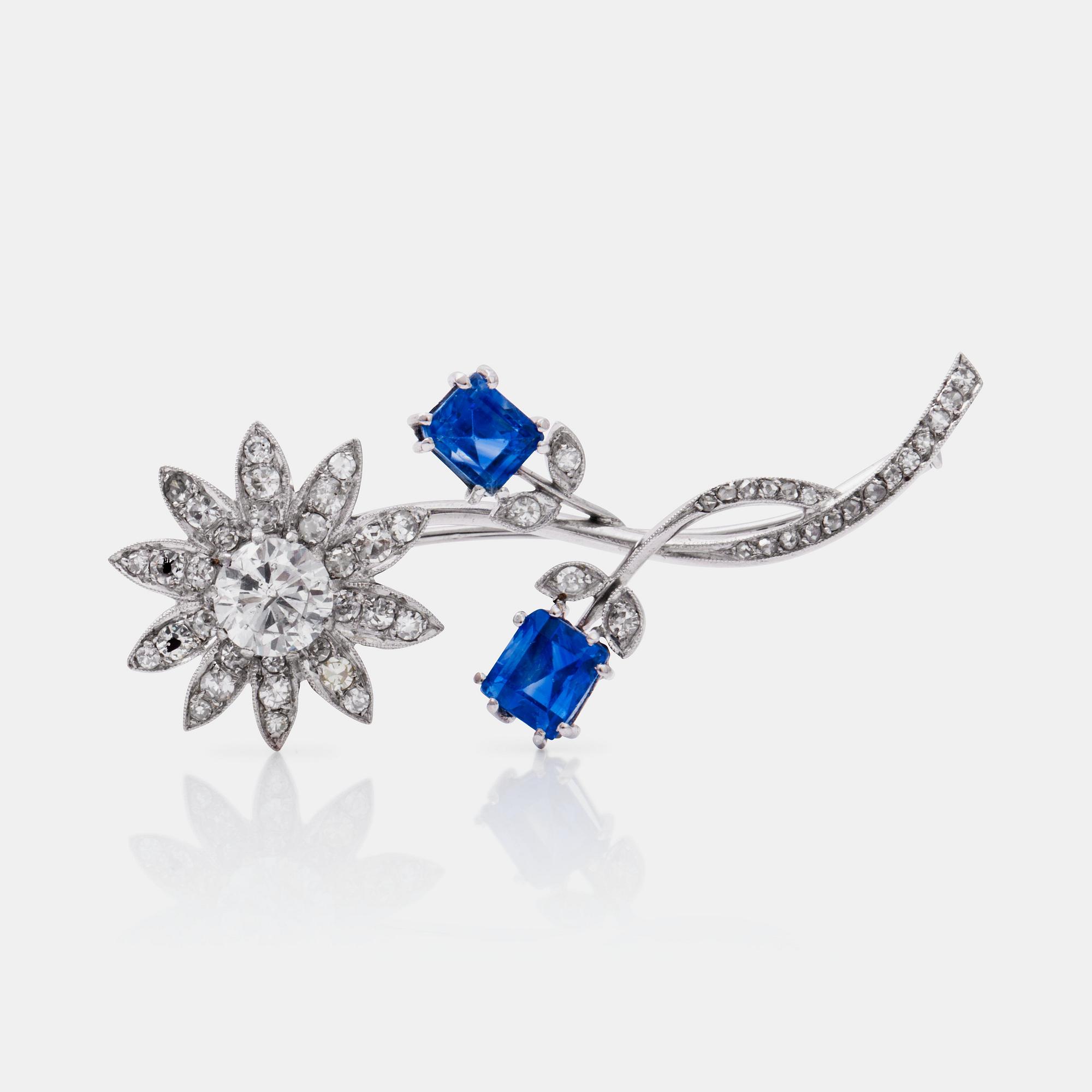 A circa 1.20 ct brilliant-cut diamond and untreated sapphire  brooch. Certificate from GCS, London.