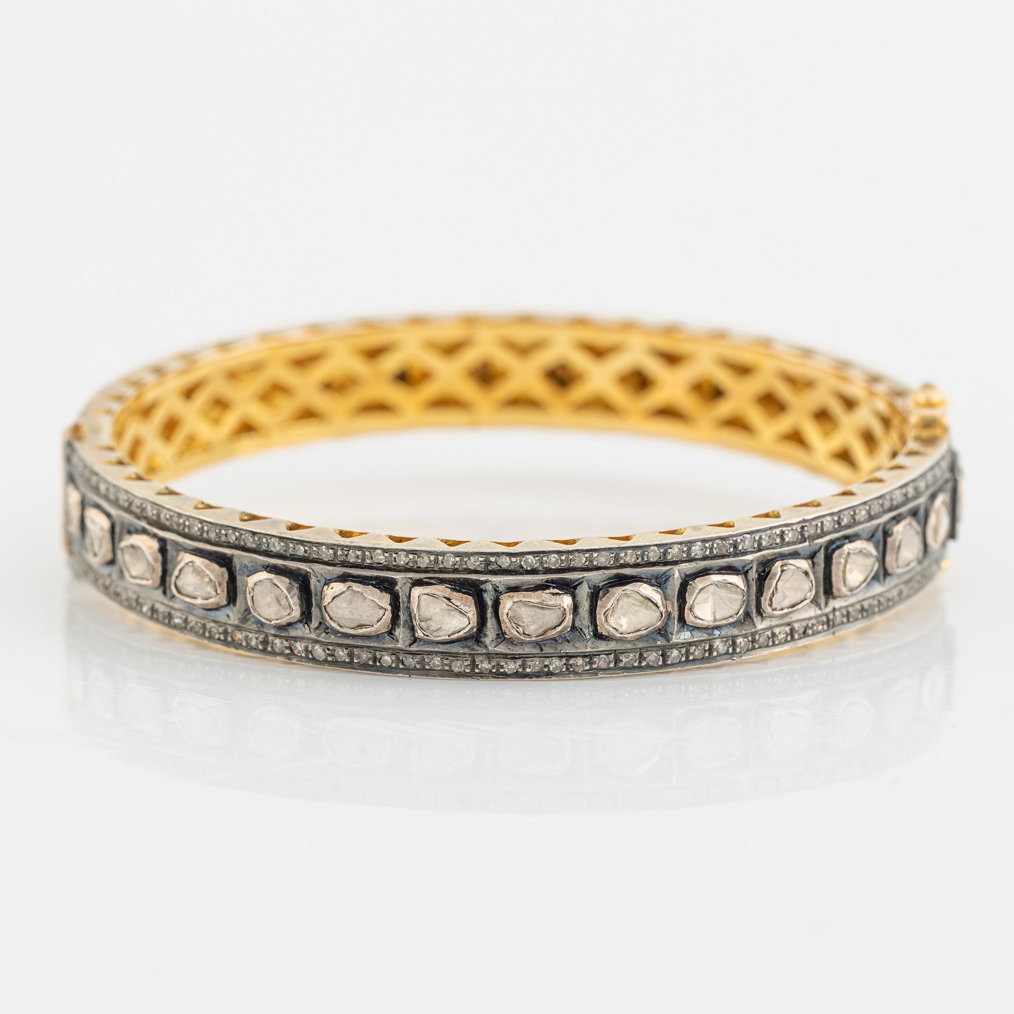 A faceted diamond bangle.