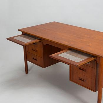 A wooden mid 20th century desk.