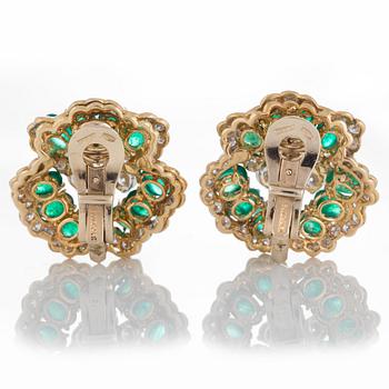 A pair of Bulgari earrings set with cabochon-cut emeralds and round brilliant-cut diamonds.