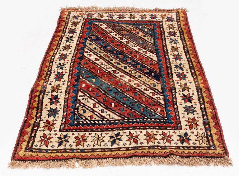 An antique Gendje rug, south Caucasus, c. 208 x 103 cm.