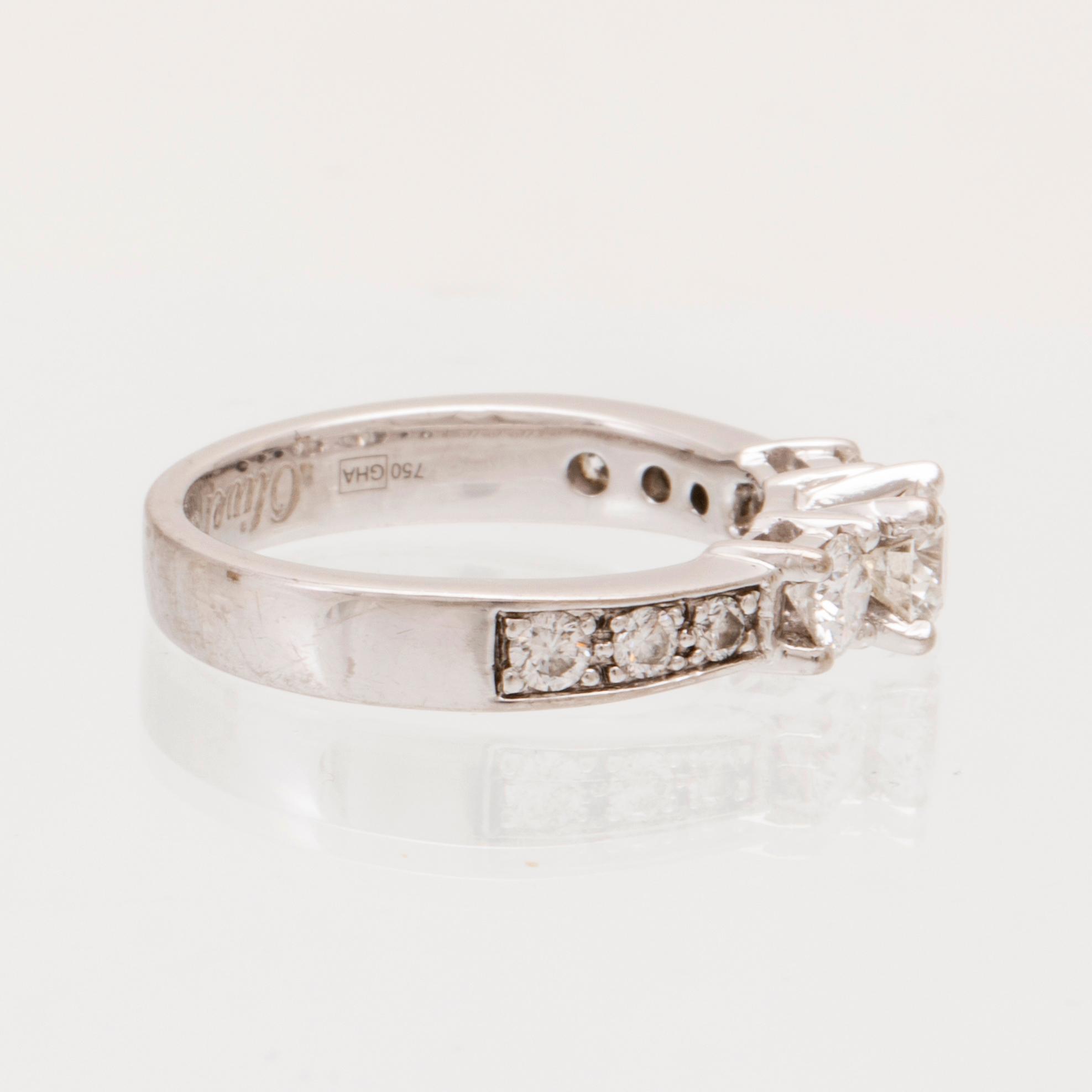 An 18K white gold ring set with round brilliant cut diamonds.