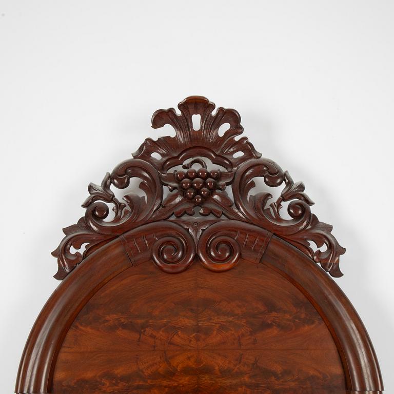 A Rococo revival mirror, late 19th Century.