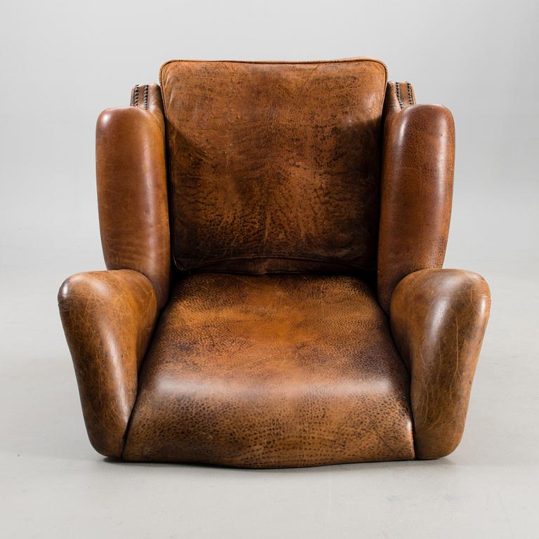 A Chesterfield style armchair from the latter part of the 20th century.