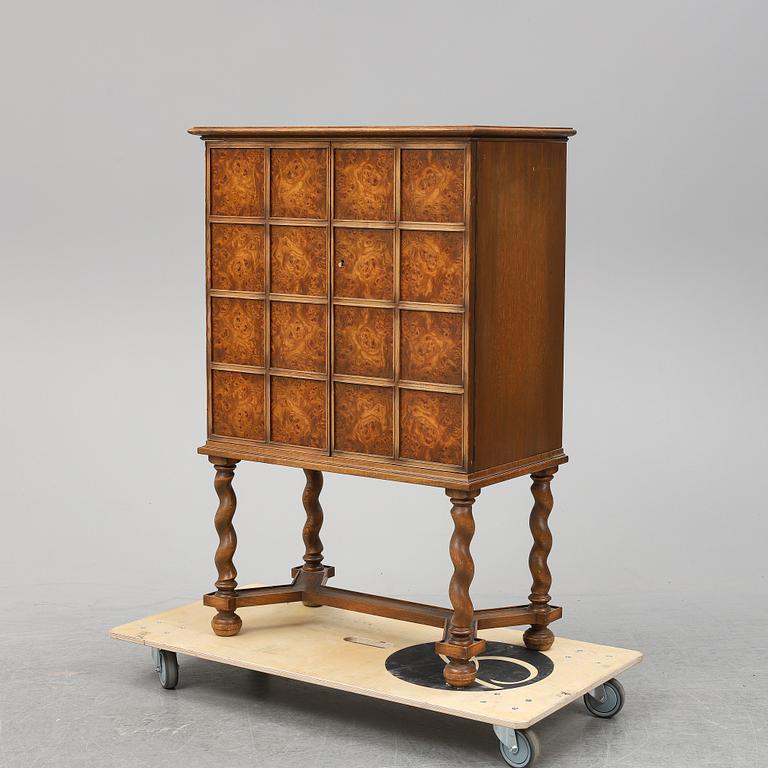 A Baroque style oak cabinet dated 1947.