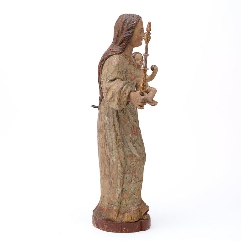 A Baroque 18th century sculpture depicting Mary with baby Jesus.