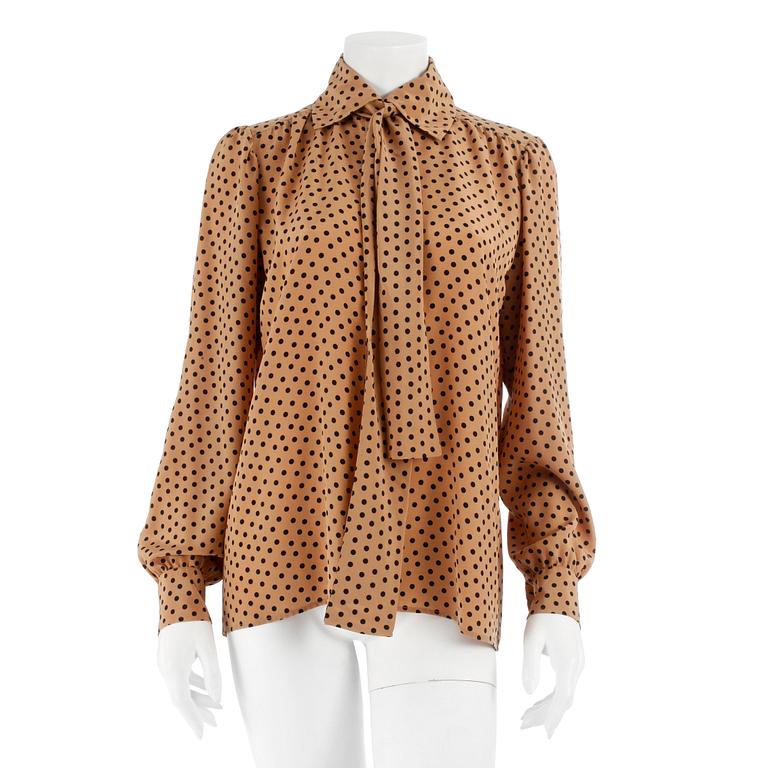 YVES SAINT LAURENT, a beige and black polka dotted blouse.
