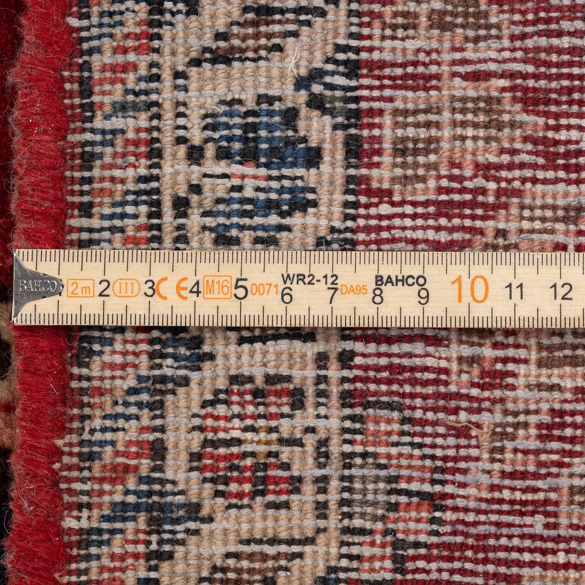 An Persian carpet, ca. 310 x 215 cm.