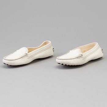 A pair of white leather loafers by Tod's.