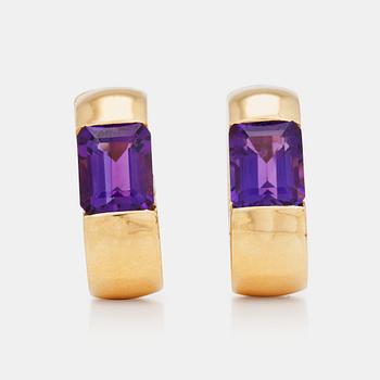 1081. A pair of gold and amethyst earrings.