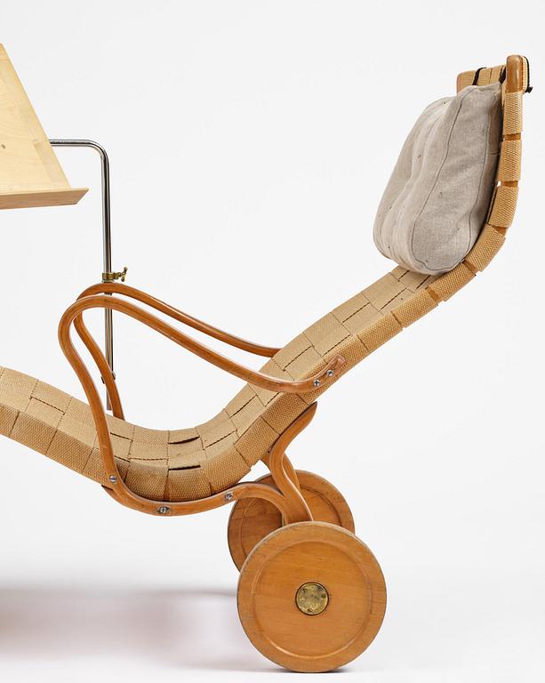 Bruno Mathsson, a lounge chair with wheels, Firma Karl Mathsson, Värnamo, 1940s, with reading table from 1972.