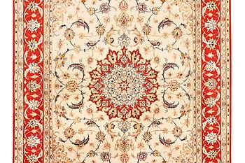 A semi-antique part silk Isfahan rug, a. 238 x 156 cm.