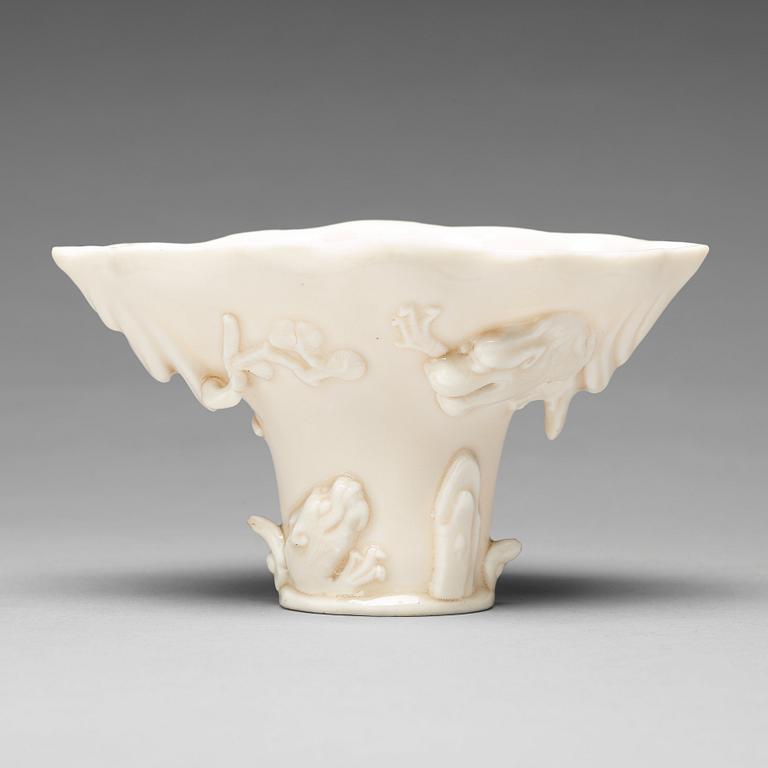 A blanc de chine rhinoserous shaped libation cup, 17th Century.