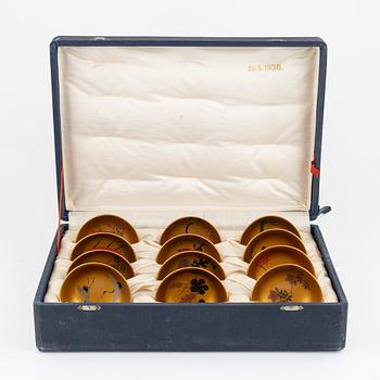 A silk clad box with twelve Japanese lacquer bowls, with dating inside the box 28/5 1930.