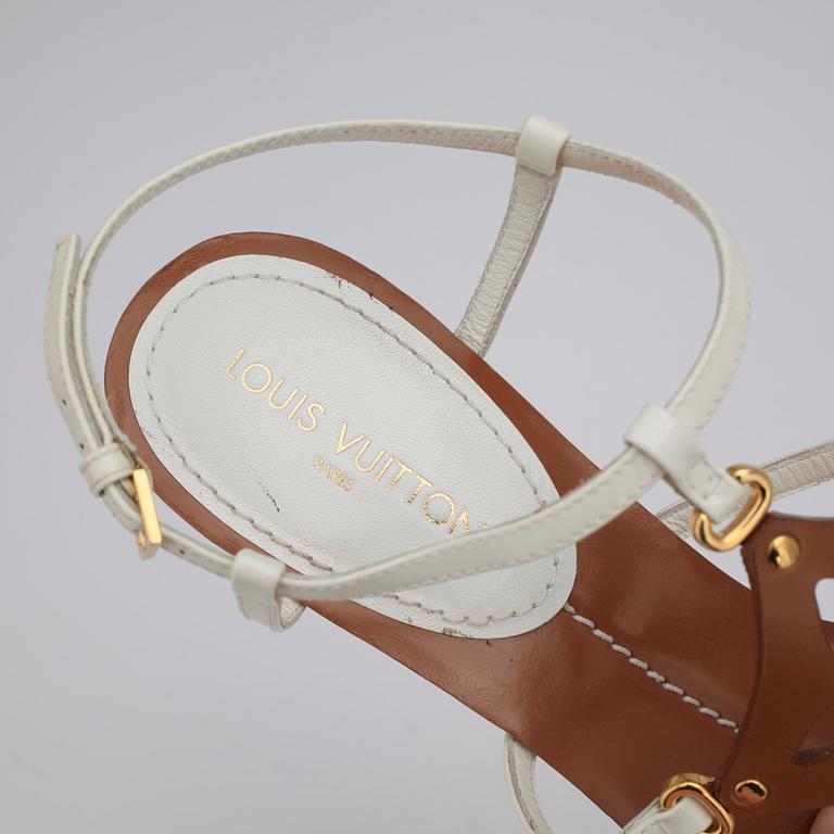 LOUIS VUITTON, a pair of white wedge heel sandalettes.