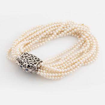 Cultured pearl bracelet, eleven strand, clasp white gold with sapphire and diamonds.