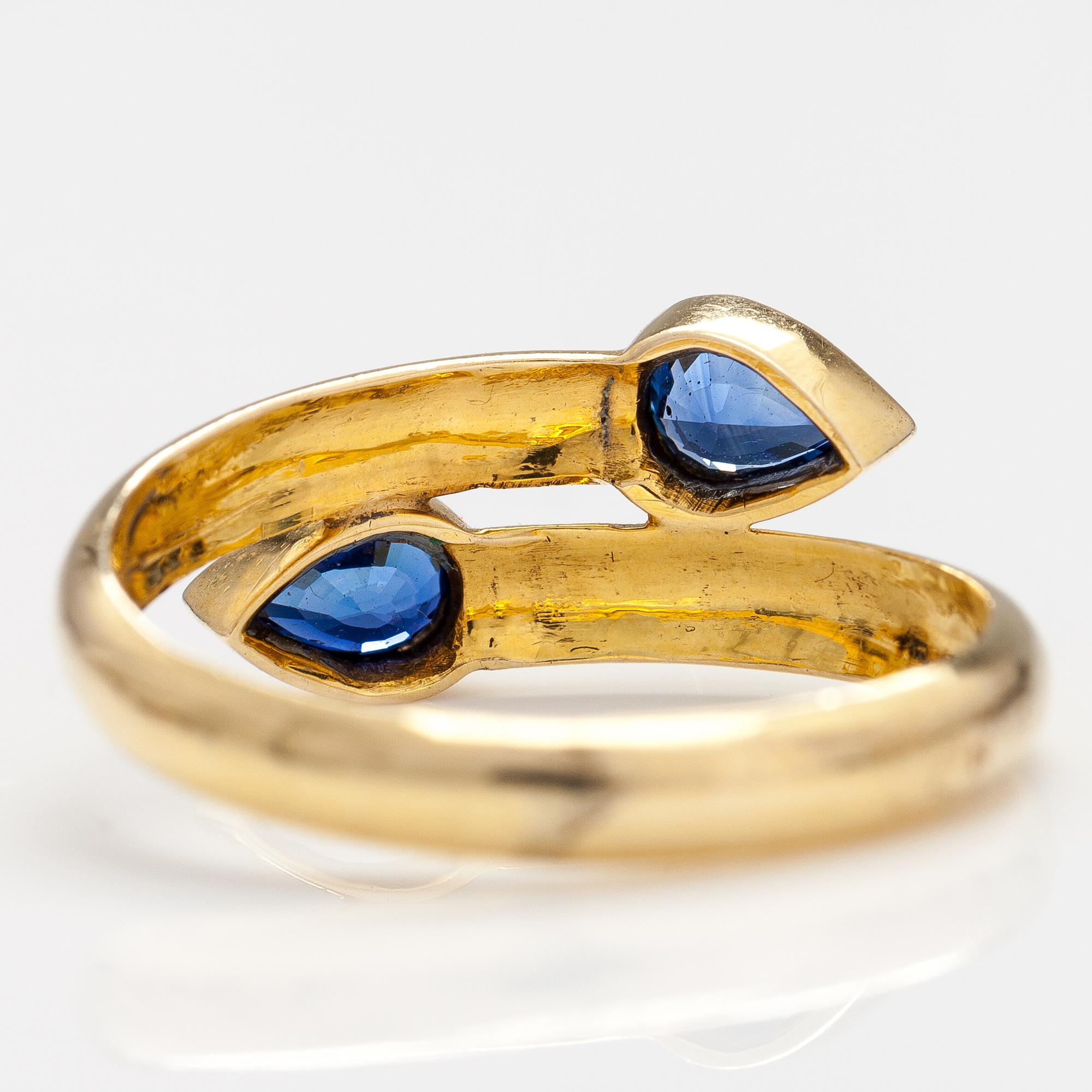An 14-18K gold ring with two sapphires.