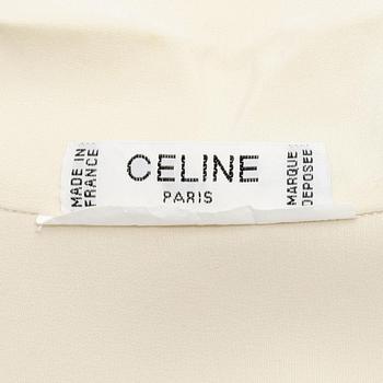 CÉLINE, a créme colored silk blouse.