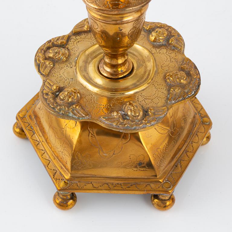 A pair of brass barock style candlesticks.