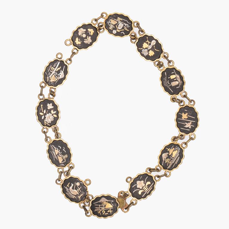 A silver-plated, gilded and lacquered metal parure from Japan, first half of the 20th century.