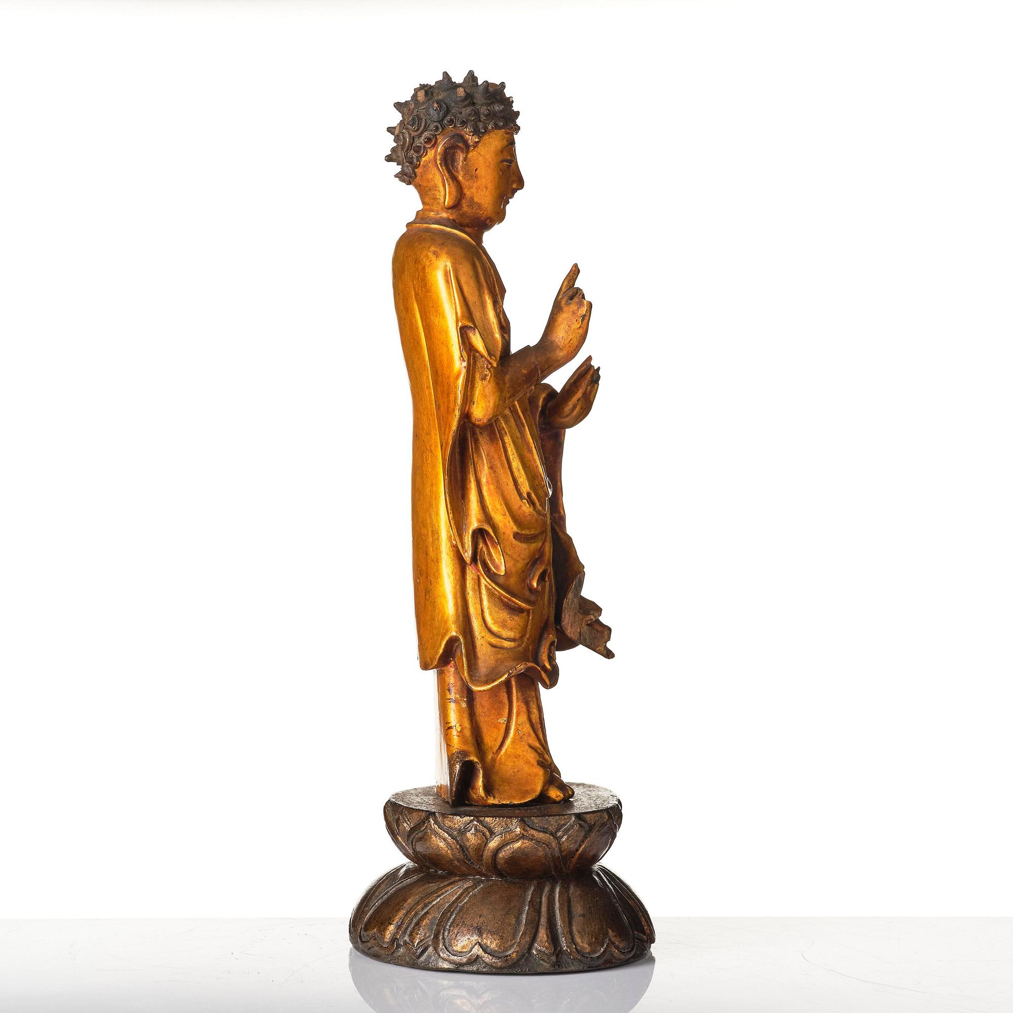 A lacquer figure of a standing Buddha, late Ming dynasty/early Qing dynasty.