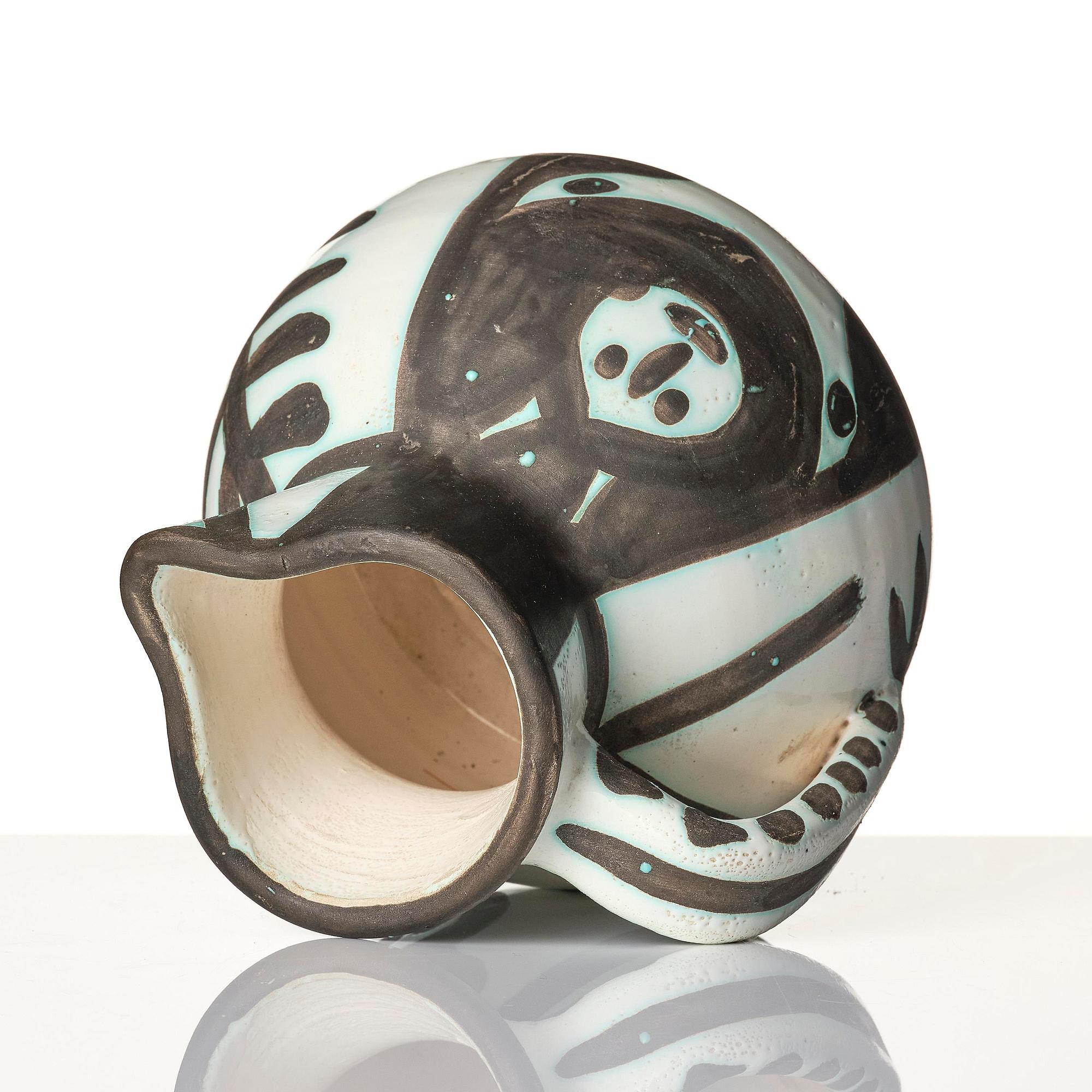 Pablo Picasso, a "Pichet petites têtes" (A.R. 222) faience pitcher, Madoura, Vallauris, France, post 1953.