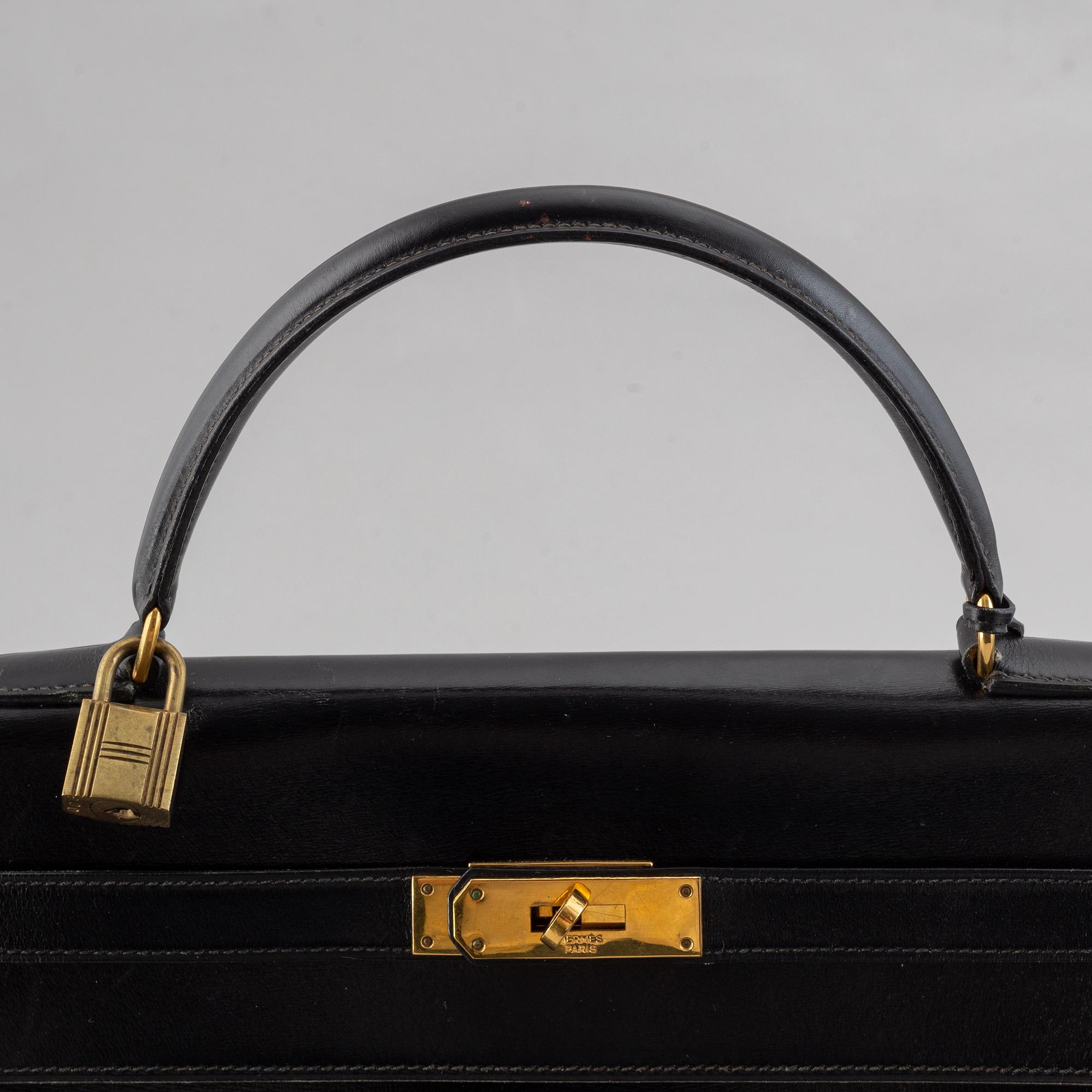 Hermès,a black leather 'Kelly 32' handbag, 1975.