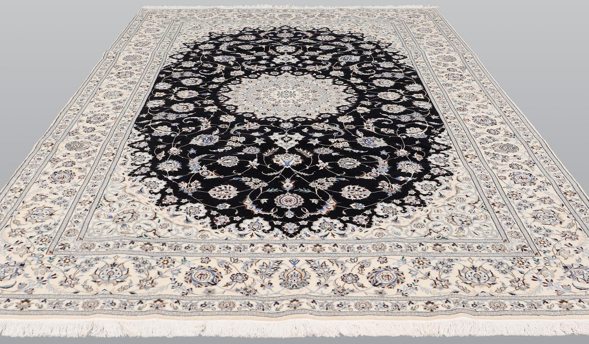 A Nain part silk carpet, 310 x 204 cm.
