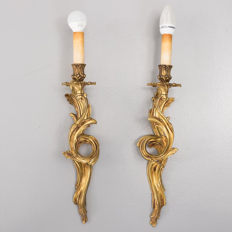 A pair of brass Rococo-style wall scones, first half of the 20th century.