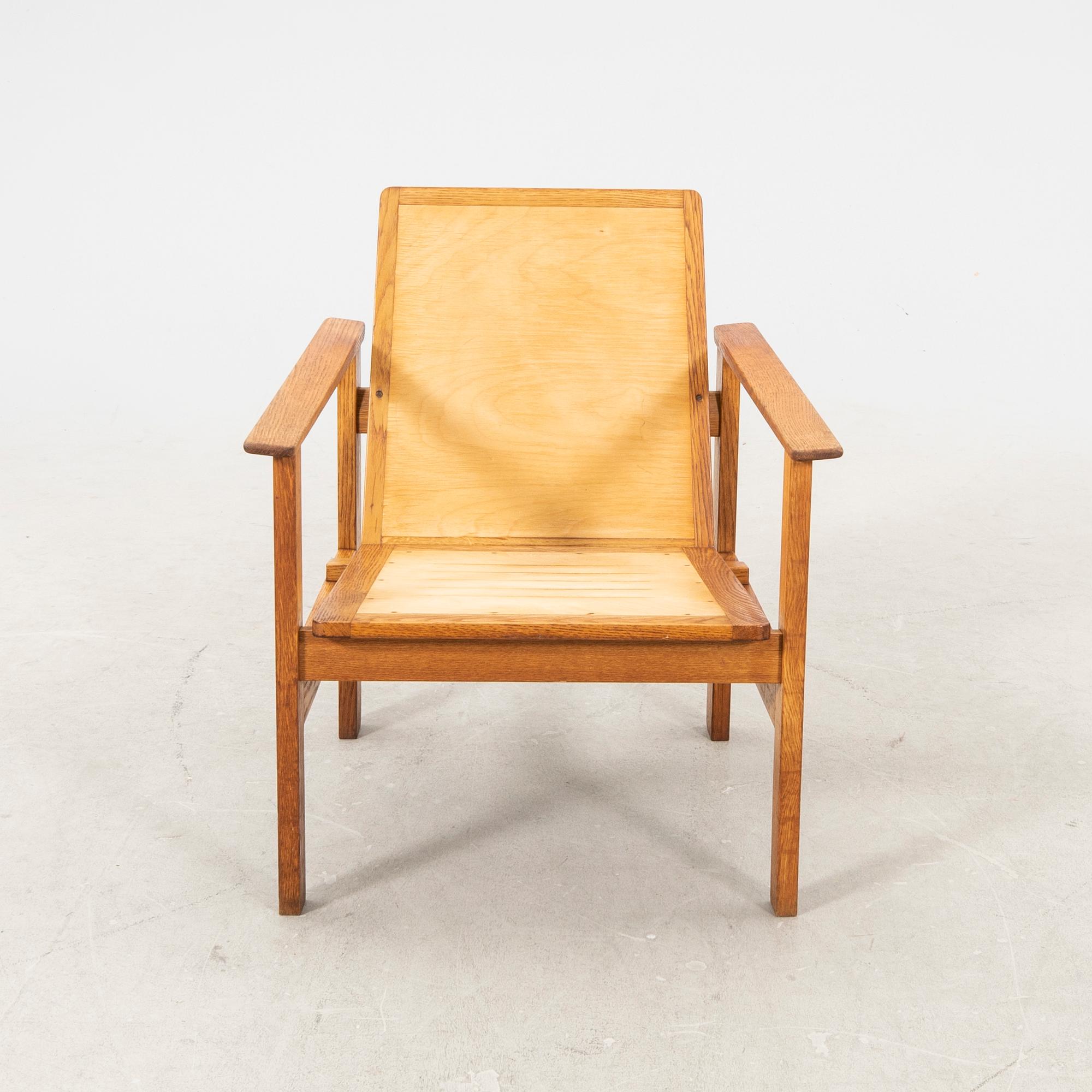 A stained wooden armchair later part of the 20th century.