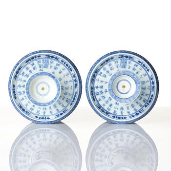 A pair of blue and white pricket candle sticks, with a poem, Qing dynasty with a Qianlong mark and of the period.