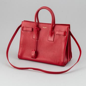 Saint Laurent, a red leather 'Sac du Jour Small' bag.