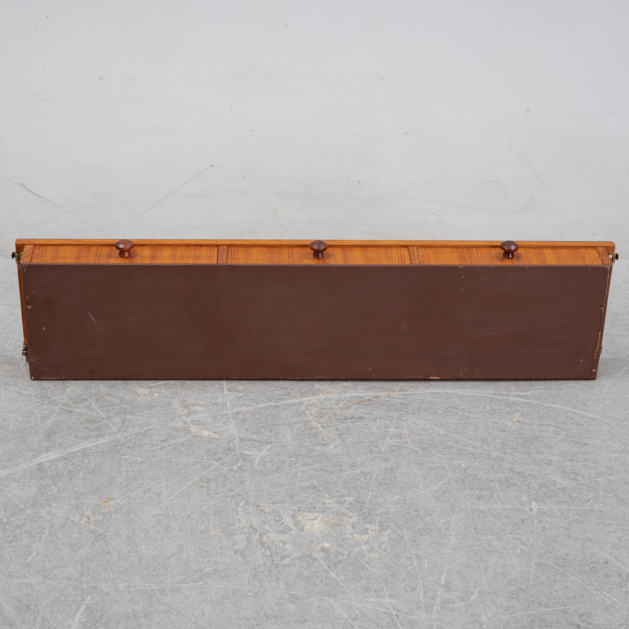 Nils Strinning, A 1950's-60's teak veneered shelf with brackets.