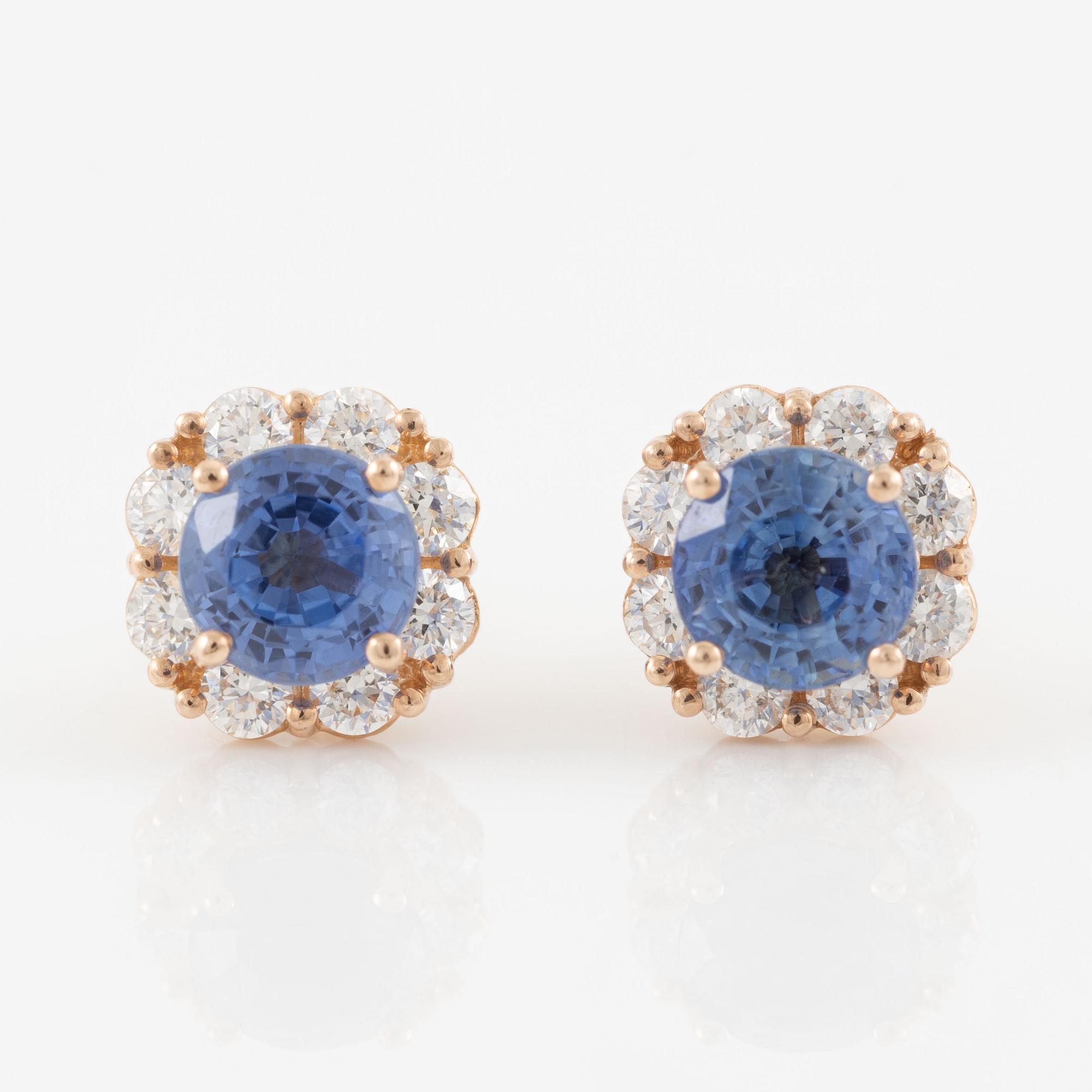 A pair of 14K gold earrings with faceted sapphires and round brilliant-cut diamonds.