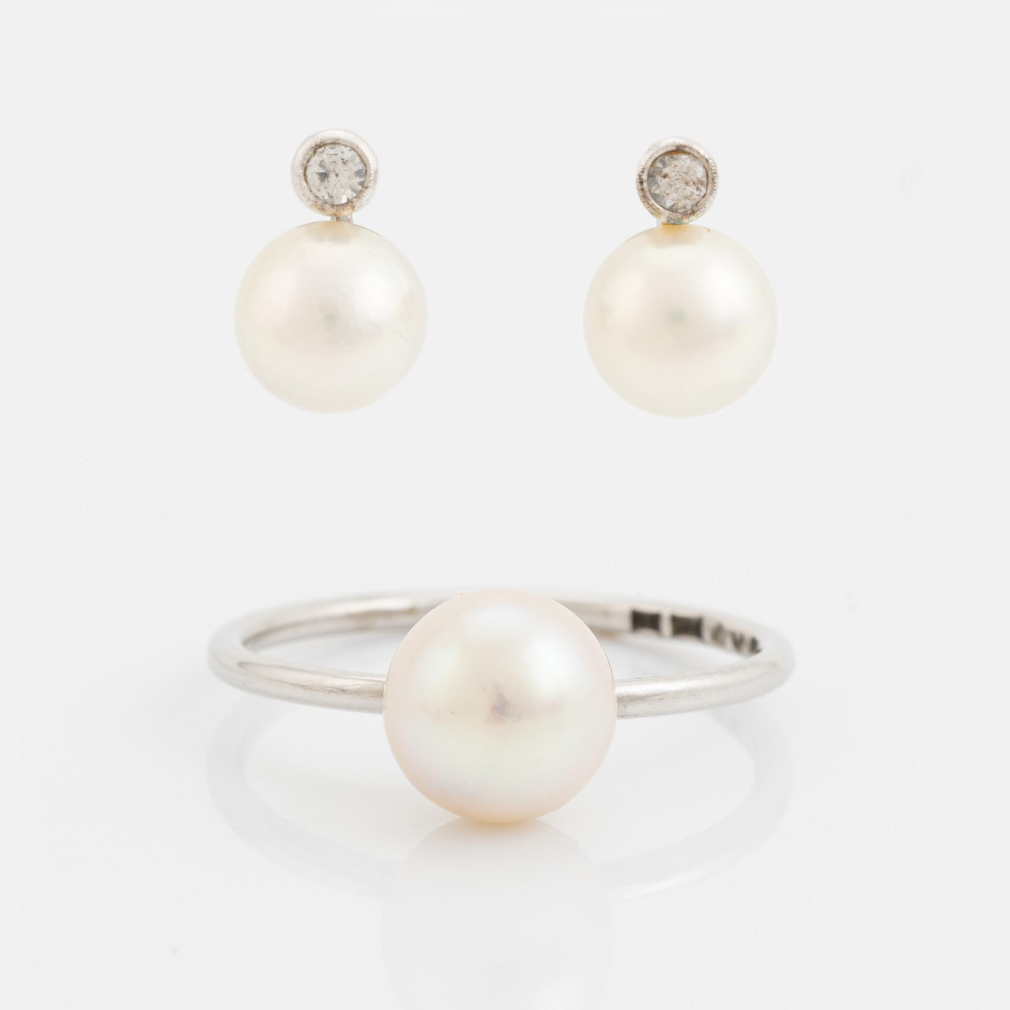 White gold earrings and ring with pearl and white stones.