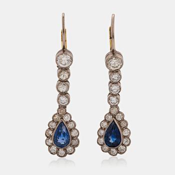 A pair of platinum and 14K gold earrings set with faceted sapphires and old-cut diamonds.