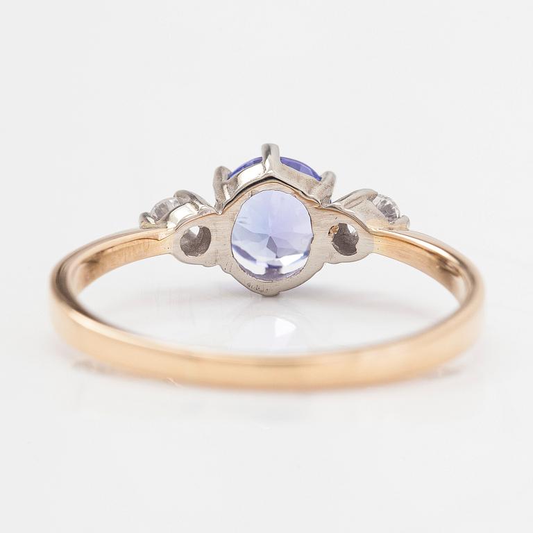 An 18K white gold ring, with a tanzanite and diamonds totalling approximately 0.04 ct.