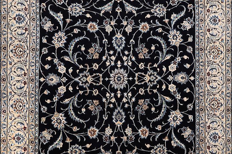 A carpet, Nain, part silk, ca. 295 x 197 cm.