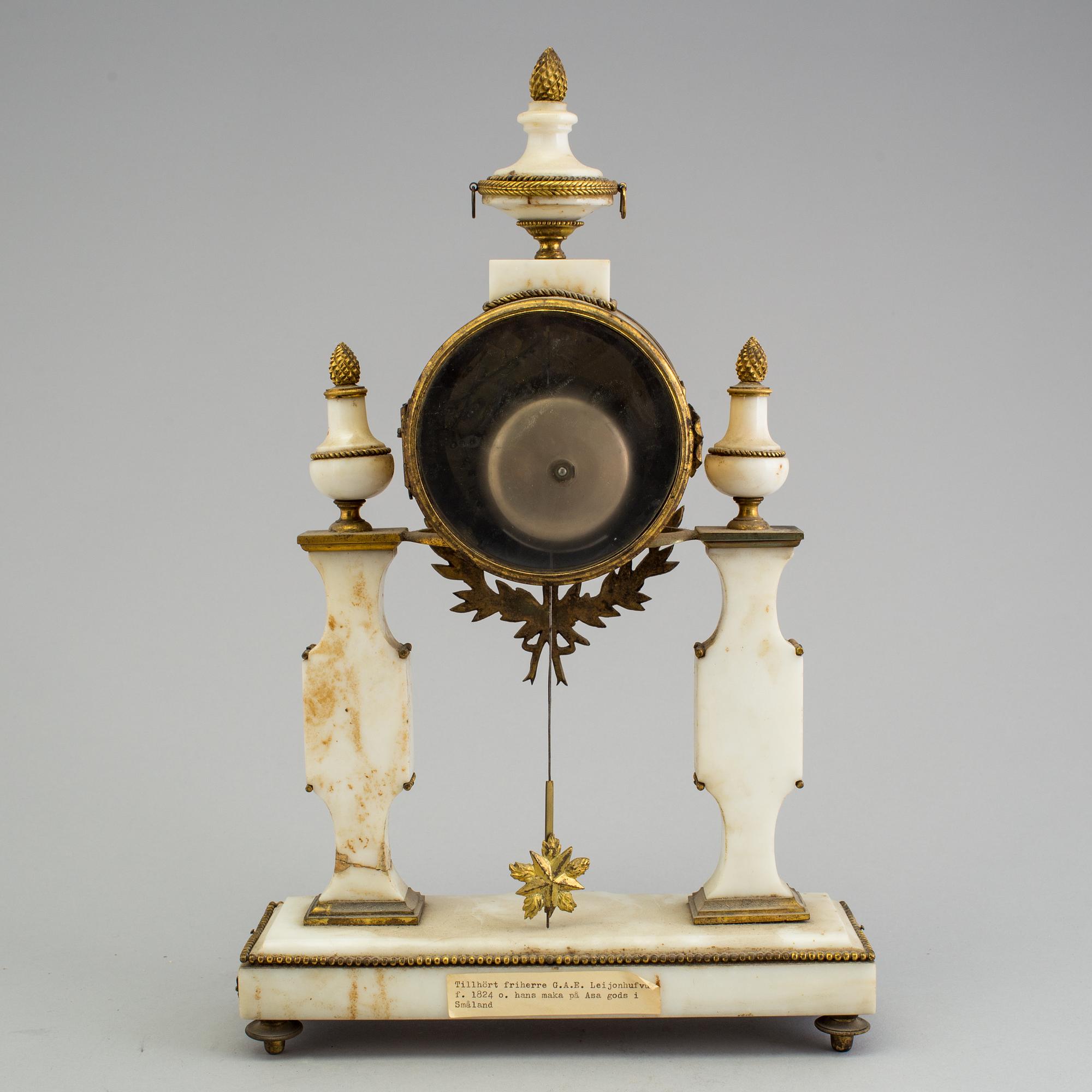 A Louis XVI marble and bronze mantel clock from the second half of the 18th century.