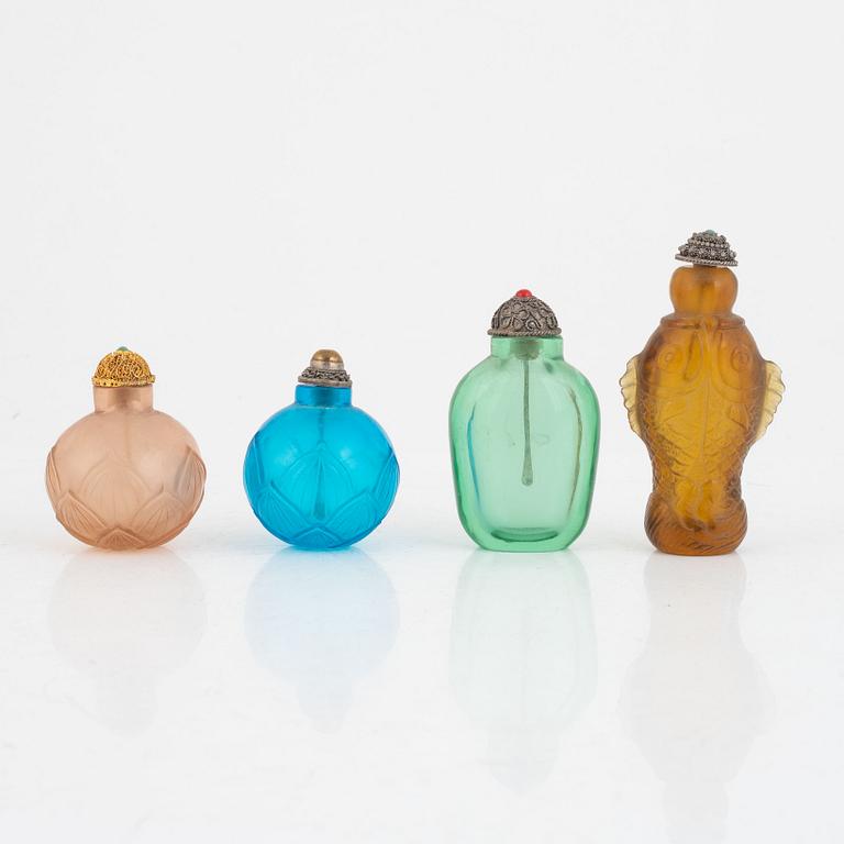 A group of four glass snuff bottles with stoppers, China, 20th century.